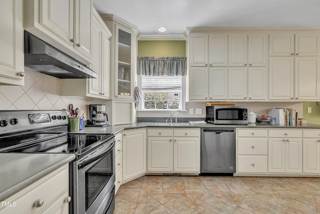 107 Stargrass Ave, Clayton, NC 27527 - kitchen featuring stainless steel appliances, under cabinet range hood, a sink, light stone finish floors, and tasteful backsplash