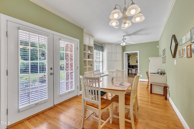 107 Stargrass Ave, Clayton, NC 27527 - dining room with french doors, crown molding, light wood finished floors, a chandelier, and baseboards