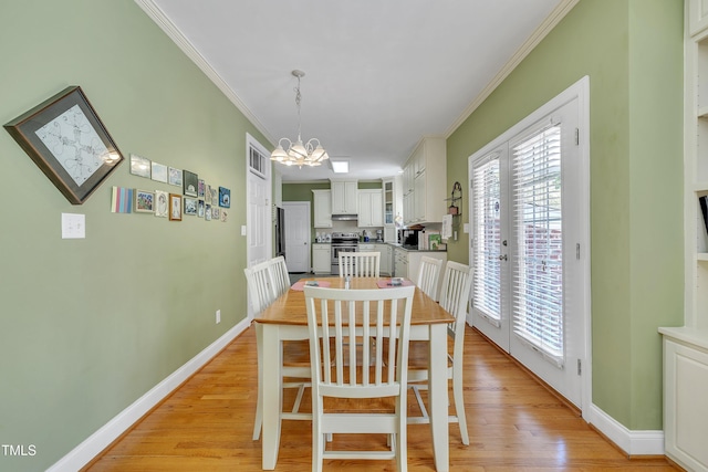 107 Stargrass Ave, Clayton, NC 27527 - dining area with crown molding, a chandelier, light wood-style floors, and baseboards