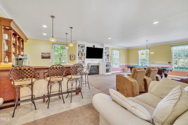 107 Stargrass Ave, Clayton, NC 27527 - living room with billiards table, ornamental molding, light carpet, recessed lighting, and a glass covered fireplace