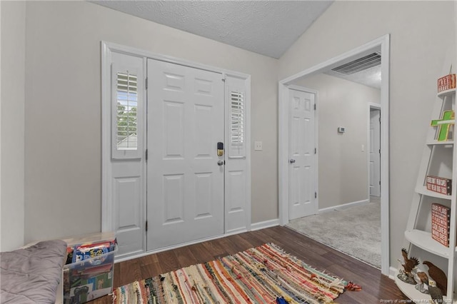 entrance foyer featuring wood finished floors, baseboards, and a textured ceiling