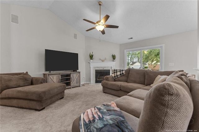 living room featuring vaulted ceiling, ceiling fan, carpet, a high end fireplace, and baseboards