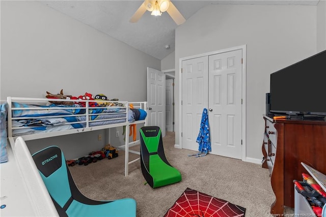 bedroom featuring lofted ceiling, carpet floors, a closet, and ceiling fan