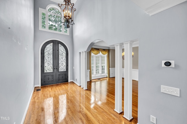 608 Greyrock Rd, Whitsett, NC 27377 - foyer entrance with arched walkways, french doors, wood finished floors, healthy amount of natural light, and a high ceiling