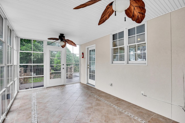 608 Greyrock Rd, Whitsett, NC 27377 - unfurnished sunroom with ceiling fan, expansive windows, inlaid floor details, and tile patterned floors