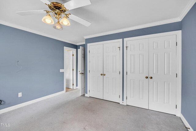 608 Greyrock Rd, Whitsett, NC 27377 - unfurnished bedroom with two closets, carpet flooring, baseboards, crown molding, and ceiling fan
