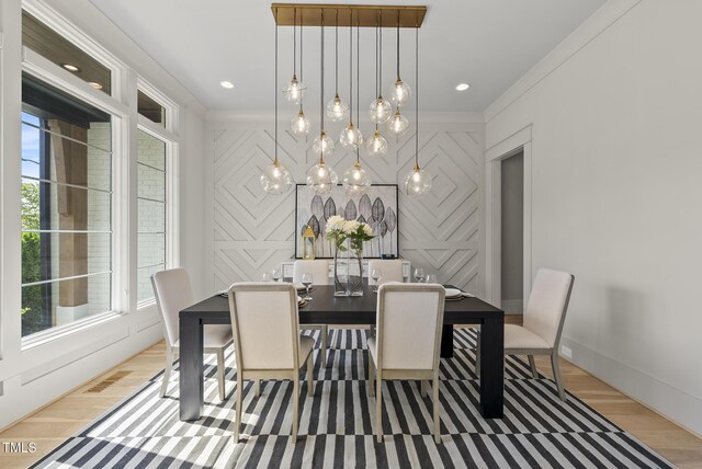 7417 Dover Hills Dr Unit 73, Wake Forest, NC 27587 - dining area featuring healthy amount of natural light, light wood-style floors, baseboards, a chandelier, and crown molding