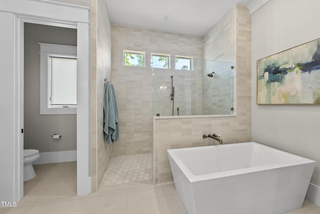 full bathroom with a walk in shower, toilet, a soaking tub, and tile patterned floors