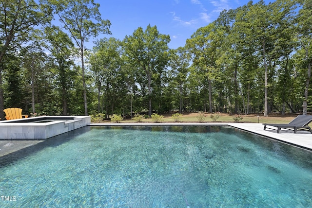 view of swimming pool with a pool with connected hot tub