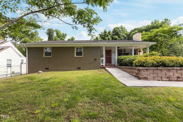 ranch-style house featuring crawl space, a front yard, a chimney, and brick siding