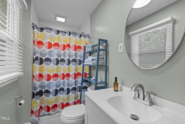 bathroom with toilet, a shower with shower curtain, and vanity