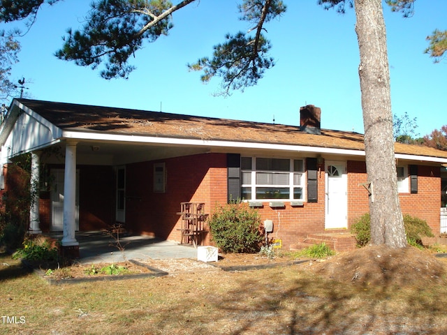 6383 Elevation Rd, Benson, NC 27504 - view of front facade with brick siding and a chimney