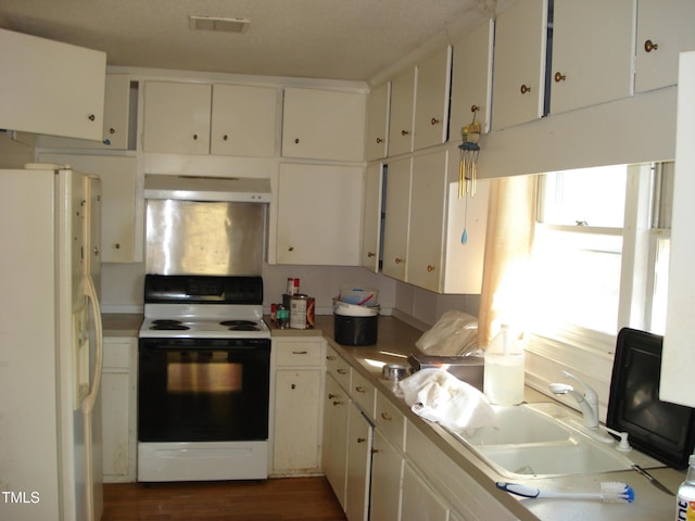 6383 Elevation Rd, Benson, NC 27504 - kitchen featuring white refrigerator with ice dispenser, range with electric stovetop, under cabinet range hood, a sink, and white cabinetry