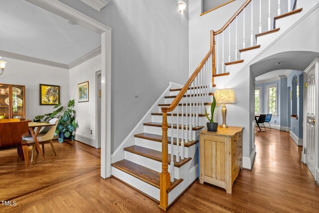 100 Michaels Way, Chapel Hill, NC 27516 - stairs featuring arched walkways, baseboards, wood finished floors, crown molding, and a chandelier