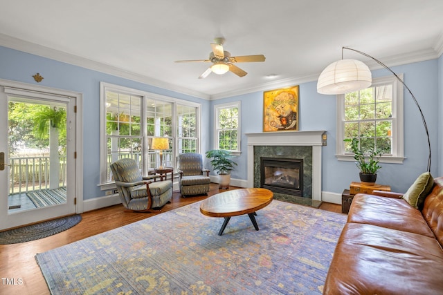 100 Michaels Way, Chapel Hill, NC 27516 - living room with crown molding, a ceiling fan, baseboards, a premium fireplace, and wood finished floors