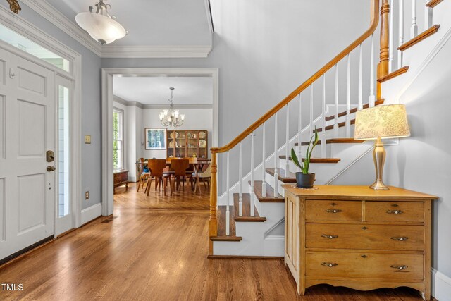 100 Michaels Way, Chapel Hill, NC 27516 - entrance foyer featuring wood finished floors, stairway, crown molding, a chandelier, and baseboards