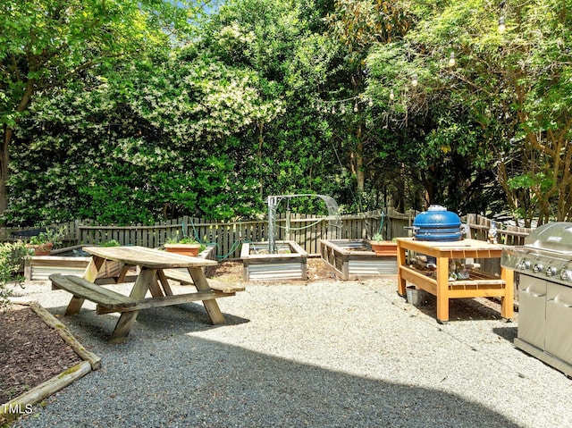 100 Michaels Way, Chapel Hill, NC 27516 - view of patio with fence, a vegetable garden, and a grill