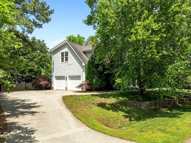 100 Michaels Way, Chapel Hill, NC 27516 - view of side of home with concrete driveway, an attached garage, and a shingled roof