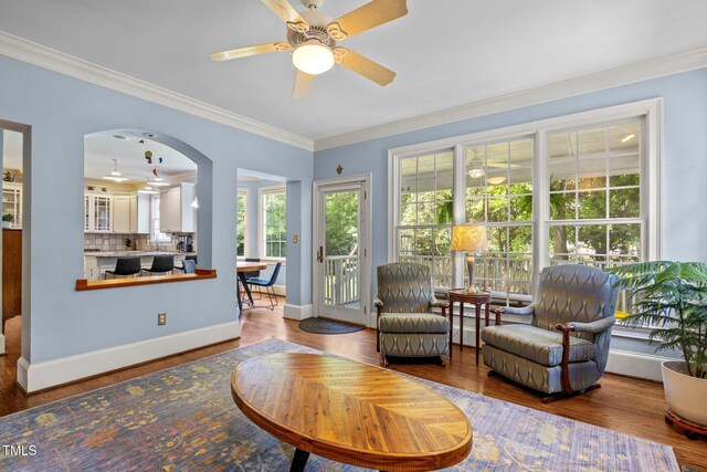 100 Michaels Way, Chapel Hill, NC 27516 - living room featuring crown molding, wood finished floors, a ceiling fan, baseboards, and arched walkways