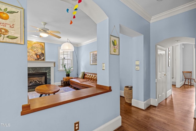 100 Michaels Way, Chapel Hill, NC 27516 - living room featuring arched walkways, ornamental molding, wood finished floors, baseboards, and a ceiling fan