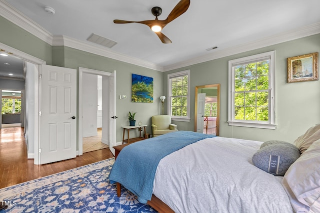 100 Michaels Way, Chapel Hill, NC 27516 - bedroom with ornamental molding, wood finished floors, multiple windows, ceiling fan, and baseboards
