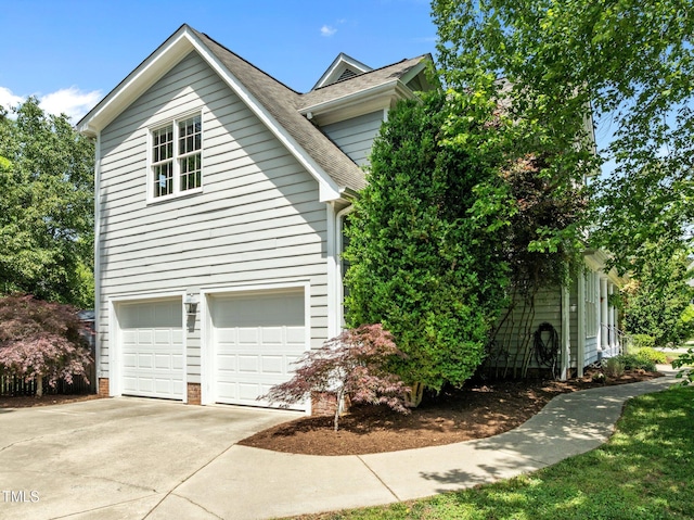 100 Michaels Way, Chapel Hill, NC 27516 - view of home's exterior with a garage, concrete driveway, and roof with shingles