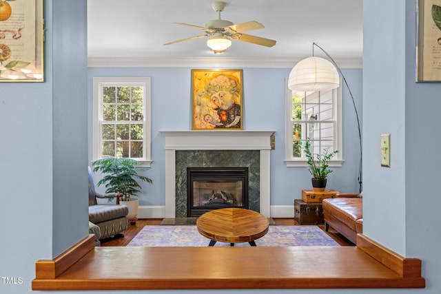 100 Michaels Way, Chapel Hill, NC 27516 - living area with a premium fireplace, wood finished floors, crown molding, a ceiling fan, and baseboards