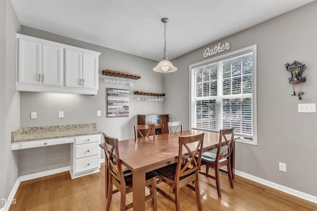 dining room with light wood-style floors and baseboards