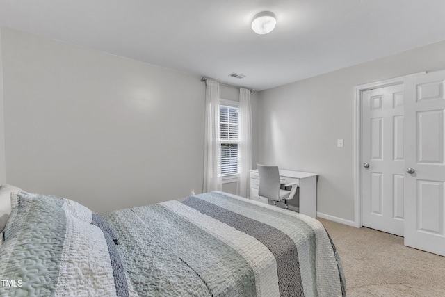 bedroom featuring light colored carpet and baseboards