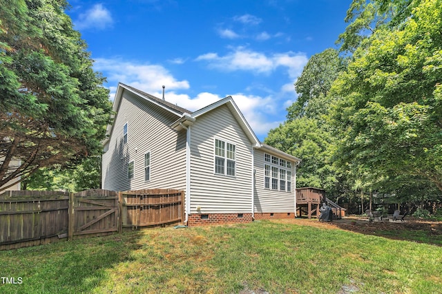 view of home's exterior with crawl space, a gate, and a deck