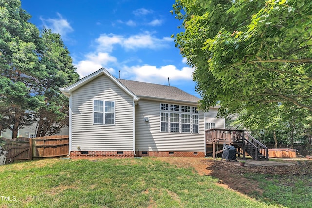 back of house featuring crawl space, a hot tub, a deck, a gate, and roof with shingles