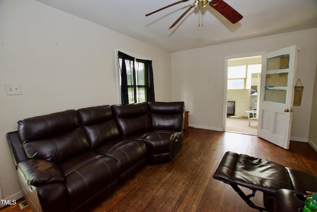 living room featuring ceiling fan, wood finished floors, and baseboards