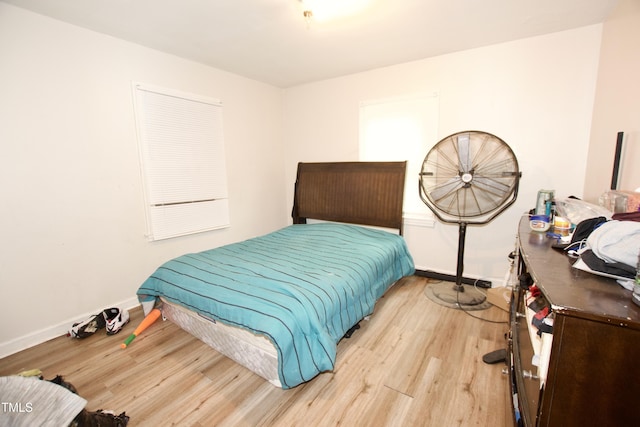 bedroom featuring wood finished floors and baseboards