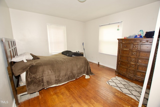 bedroom featuring wood finished floors and baseboards