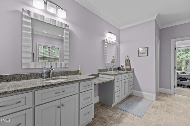 4306 Infinity Ln, Durham, NC 27705 - bathroom featuring two vanities, ornamental molding, baseboards, and stone finish flooring