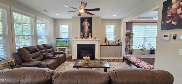 living room featuring ceiling fan, healthy amount of natural light, wood finished floors, recessed lighting, and a glass covered fireplace