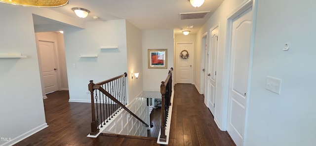 hallway featuring an upstairs landing, wood finished floors, and baseboards