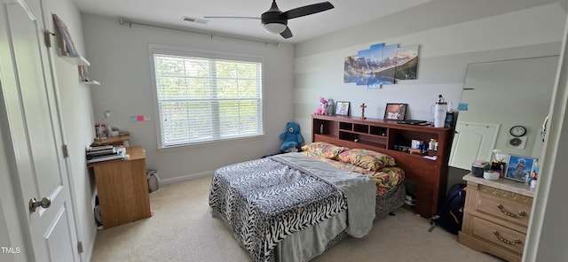 bedroom with light carpet, baseboards, and a ceiling fan