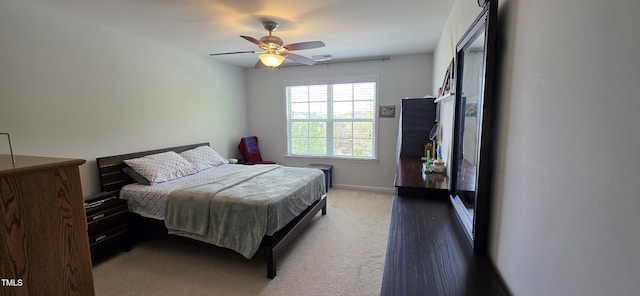bedroom featuring carpet, a ceiling fan, and baseboards