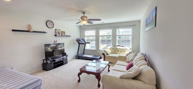carpeted living area featuring ceiling fan and baseboards