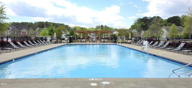 community pool with fence, a patio area, and a pergola
