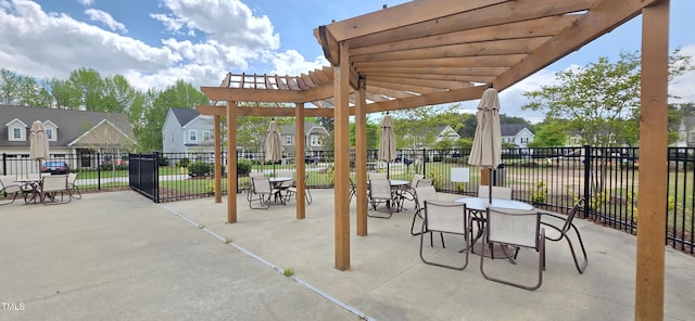 view of patio with a pergola, fence, outdoor dining area, and a residential view