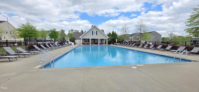 community pool featuring fence and a patio
