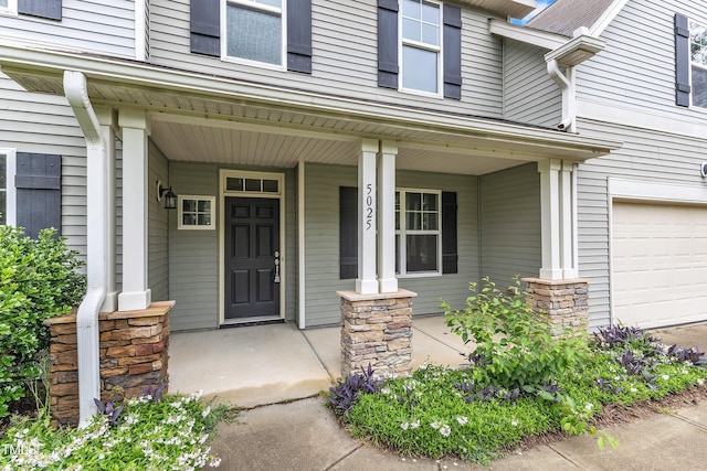 5025 Stonewood Pines Dr, Knightdale, NC 27545 - property entrance with covered porch and a garage
