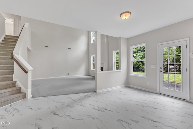 5025 Stonewood Pines Dr, Knightdale, NC 27545 - empty room with marble look tile flooring, stairway, and baseboards