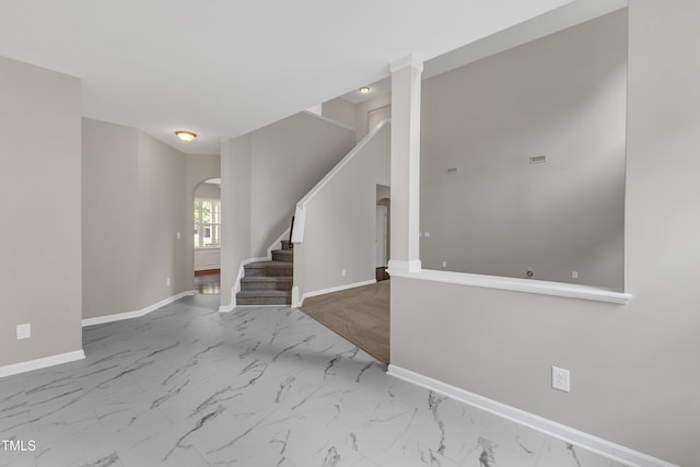 5025 Stonewood Pines Dr, Knightdale, NC 27545 - entrance foyer with arched walkways, baseboards, marble look tiles, and stairway