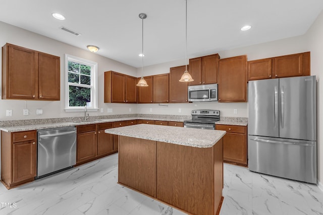 5025 Stonewood Pines Dr, Knightdale, NC 27545 - kitchen with appliances with stainless steel finishes, light marble finish flooring, brown cabinets, pendant lighting, and a sink