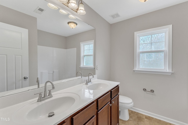 5025 Stonewood Pines Dr, Knightdale, NC 27545 - bathroom with toilet, baseboards, double vanity, and a shower