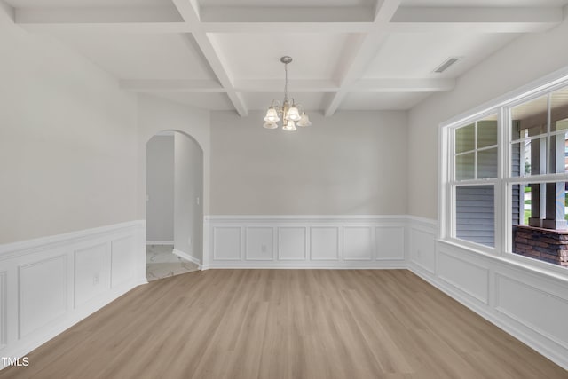 5025 Stonewood Pines Dr, Knightdale, NC 27545 - spare room featuring arched walkways, light wood-style floors, coffered ceiling, a chandelier, and beam ceiling
