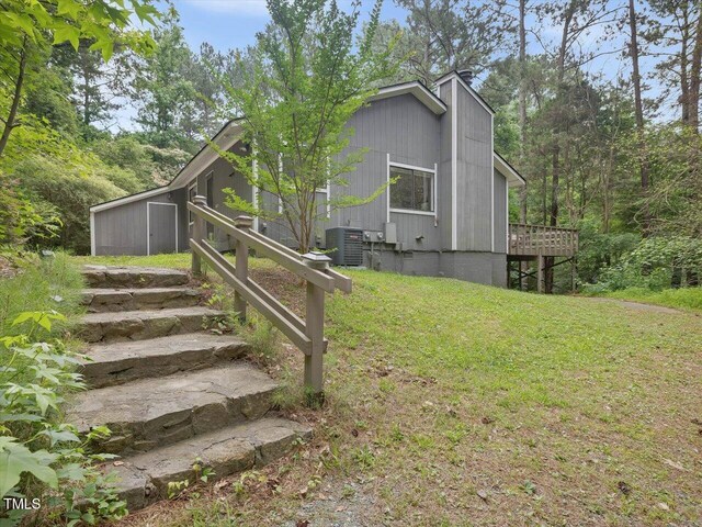 152A Cedar Ter, Chapel Hill, NC 27516 - view of property exterior featuring a lawn, a chimney, and a wooden deck